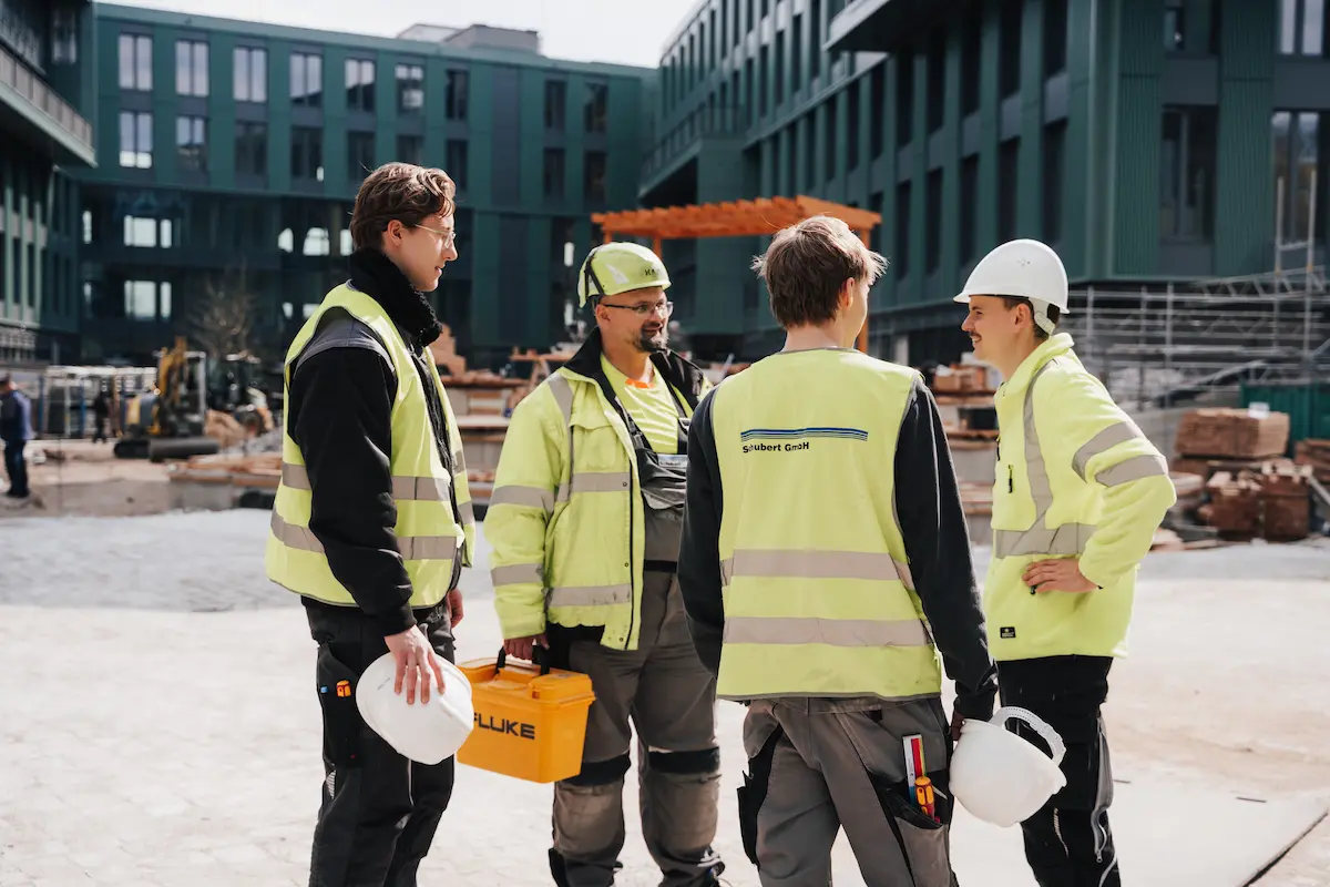 Construction workers discussing plans at building site