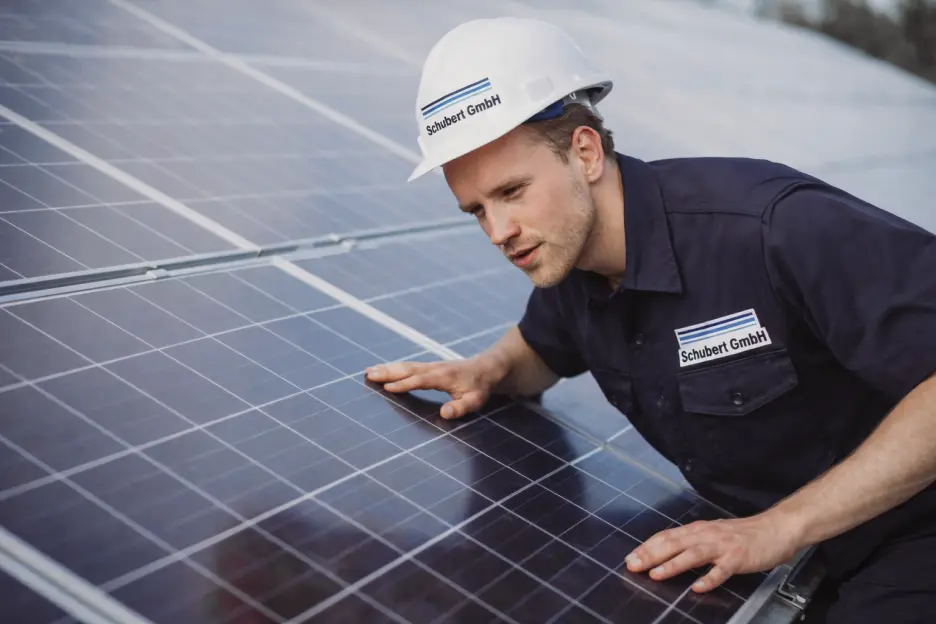 Technician inspecting solar panels