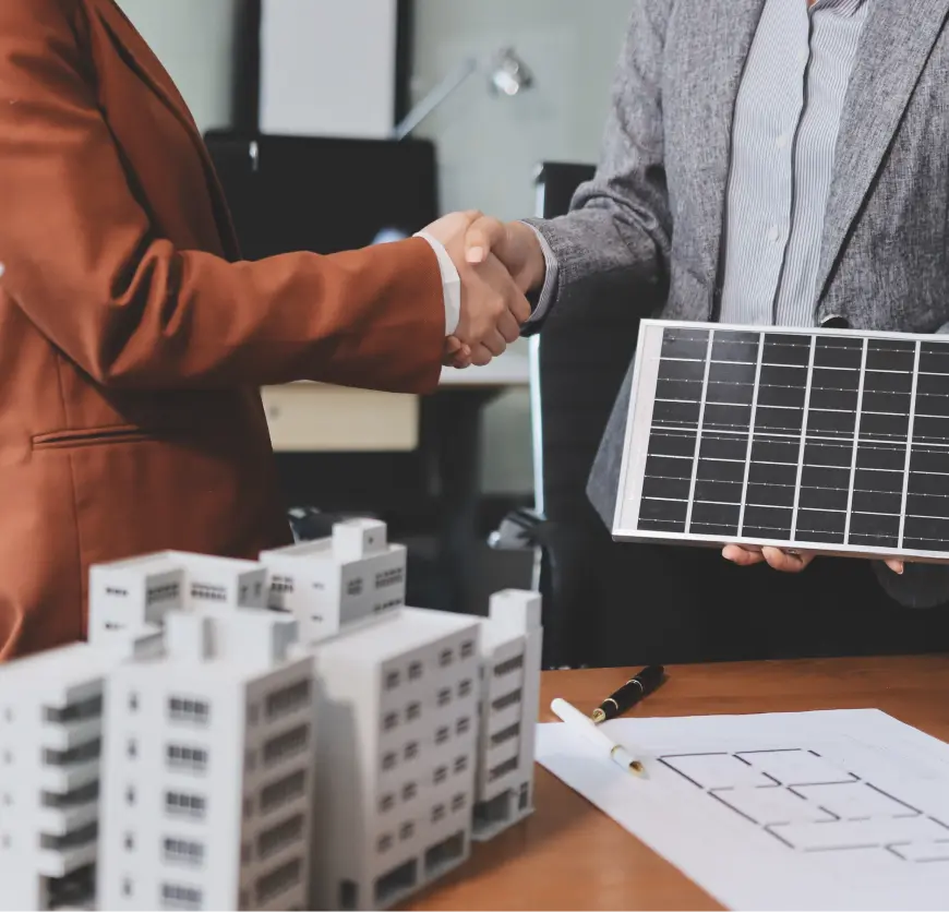 Handshake with solar panel and model buildings