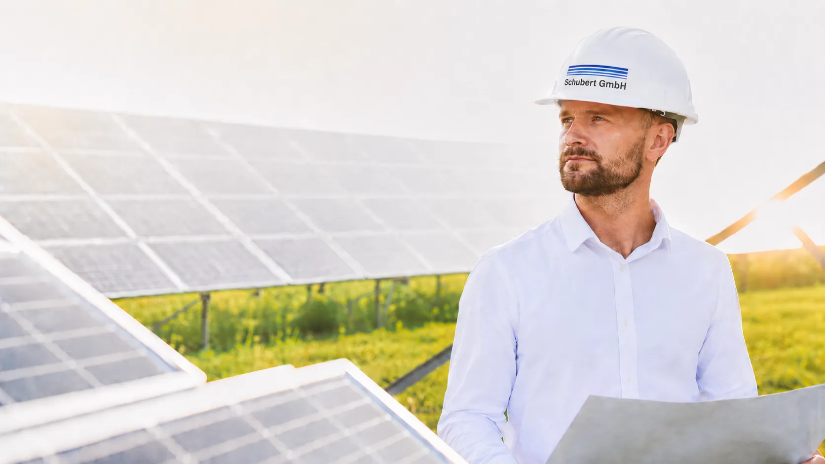 Engineer inspecting solar panels at solar farm