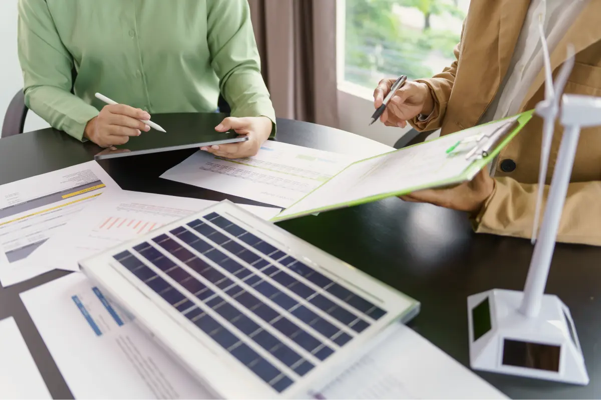 People discussing renewable energy on documents